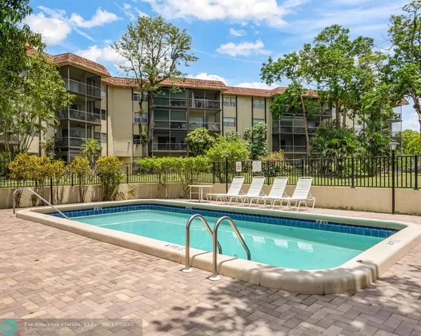 a view of a house with swimming pool and a porch