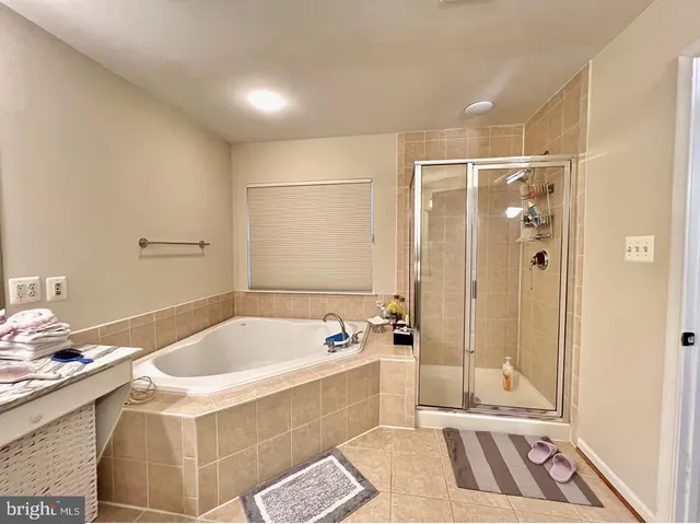 a bathroom with a tub a sink and a shower