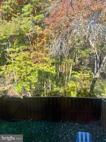 a view of a balcony with chairs and a potted plant