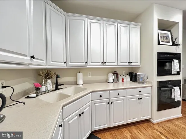a kitchen with stainless steel appliances granite countertop a sink a stove and cabinets