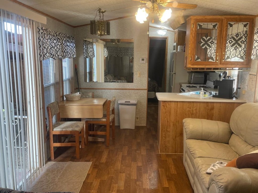 19831 West Rr 337 Camp Camp Wood, TX 78833 - Photo 4 of 27 a living room with furniture a large window and stainless steel appliances