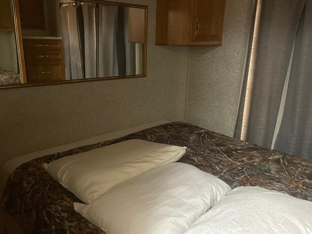 19831 West Rr 337 Camp Camp Wood, TX 78833 - Photo 5 of 27 a bedroom with a bed and wooden floor