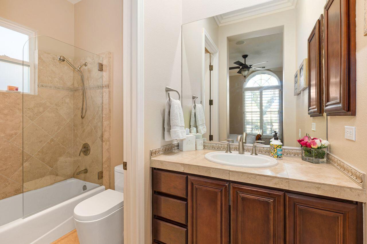 20 Vista Encantada Rancho Mirage, CA 92270 - Photo 22 of 37 a bathroom with a double vanity sink toilet mirror and bathtub