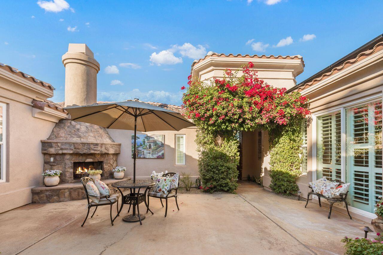 20 Vista Encantada Rancho Mirage, CA 92270 - Photo 3 of 37 a view of a patio with a table and chairs under an umbrella