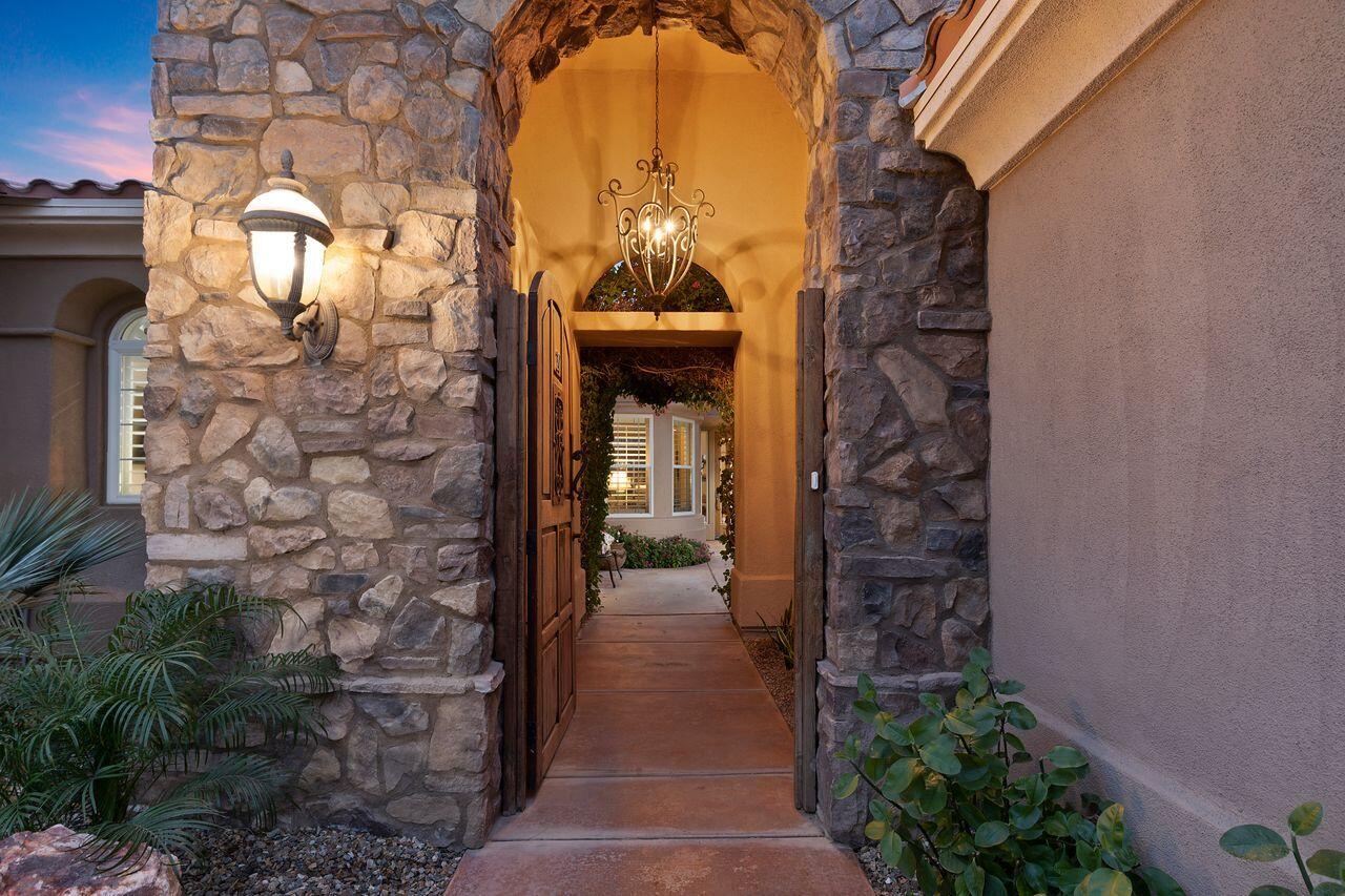 20 Vista Encantada Rancho Mirage, CA 92270 - Photo 31 of 37 a hallway with flowers in front of door