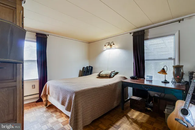 a bedroom with a bed and a desk