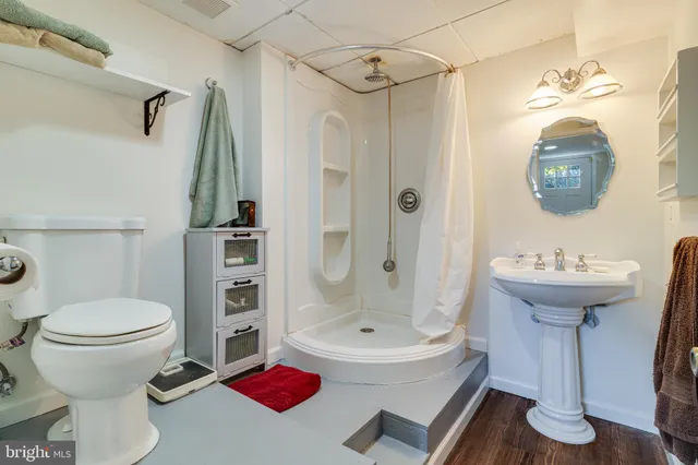 a bathroom with a sink toilet and shower