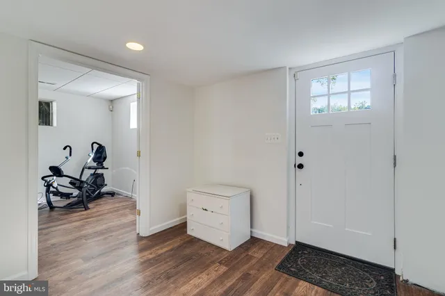 a view of a room with wooden floor and furniture