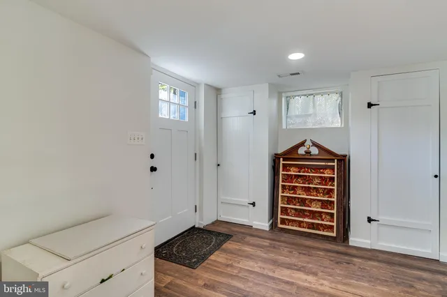 a view of kitchen with wooden floor and electronic appliances