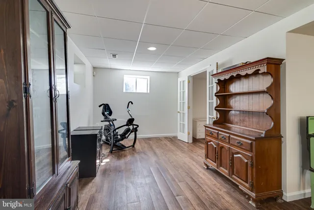 a view of a room with wooden floor and furniture