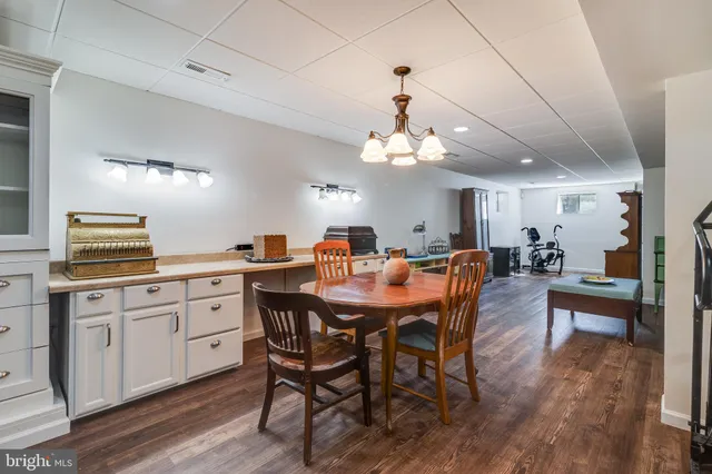 a large kitchen with a table and chairs
