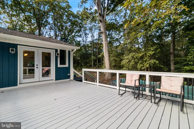 a view of roof deck with furniture and trees around