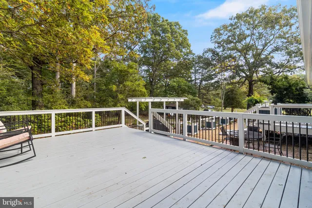 a view of a balcony with wooden floor and fence