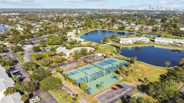 a view of a house with a small yard and wooden fence