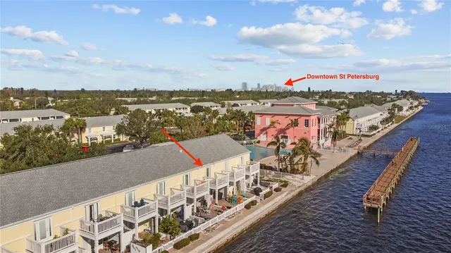 a view of a house with a yard and large trees