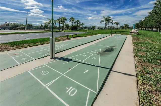 a bedroom with two beds and a chandelier