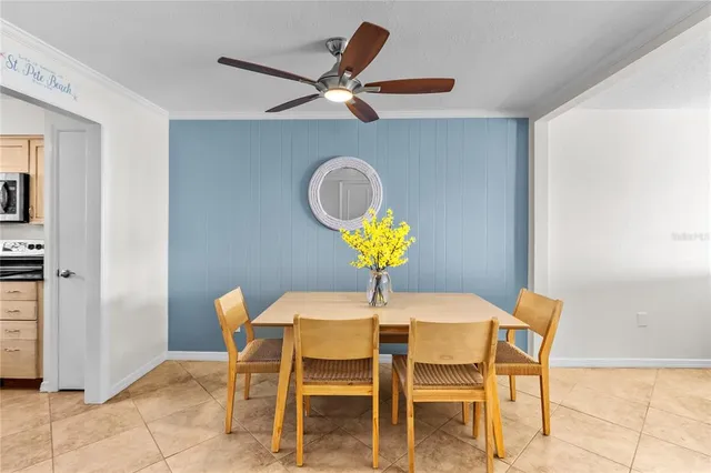 a dining room with furniture and a chandelier