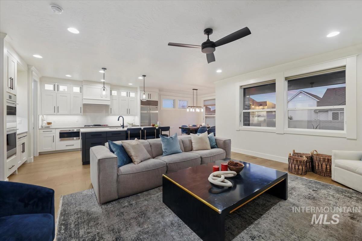 4705 North Morpheus Place Meridian, ID 83646 - Photo 22 of 45 Living area with light wood-style flooring, a ceiling fan, and recessed lighting