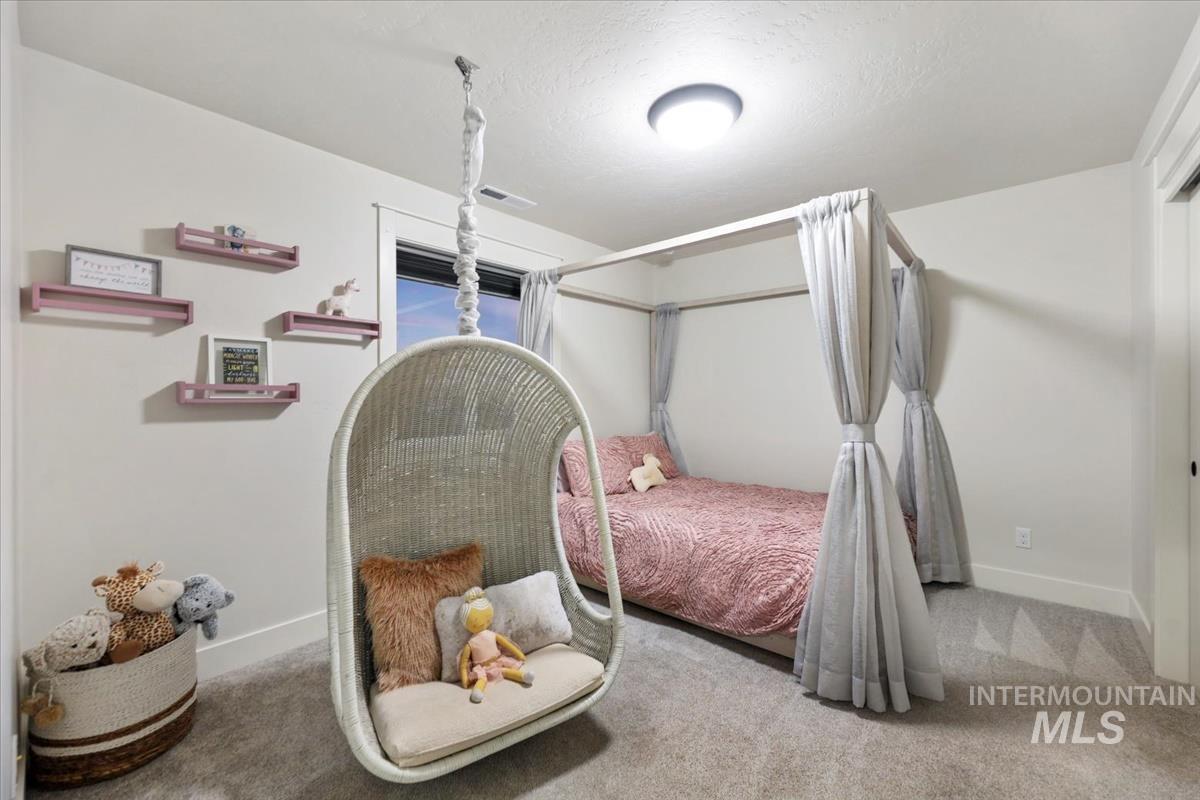 4705 North Morpheus Place Meridian, ID 83646 - Photo 32 of 45 Carpeted bedroom with a textured ceiling and baseboards