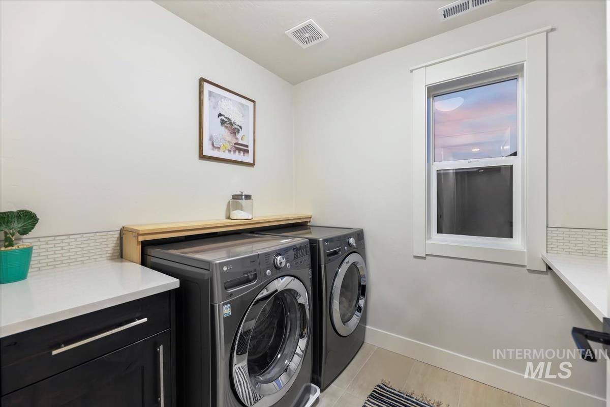 4705 North Morpheus Place Meridian, ID 83646 - Photo 37 of 45 Laundry room featuring light tile patterned floors and washing machine and clothes dryer