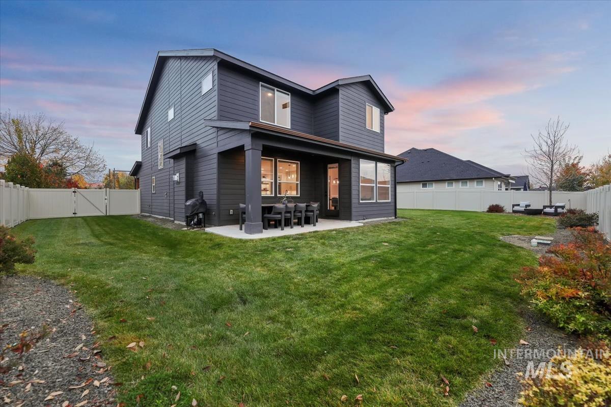 4705 North Morpheus Place Meridian, ID 83646 - Photo 43 of 45 Back of house featuring a patio, a fenced backyard, and a gate