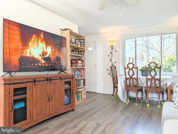 a living room with furniture a bookshelf and a large window