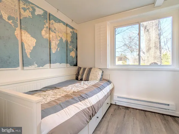 a bedroom with a bed and a large window