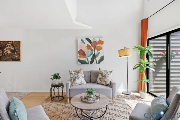 a living room with furniture and kitchen view