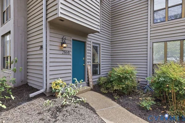 a view of a house with potted plants