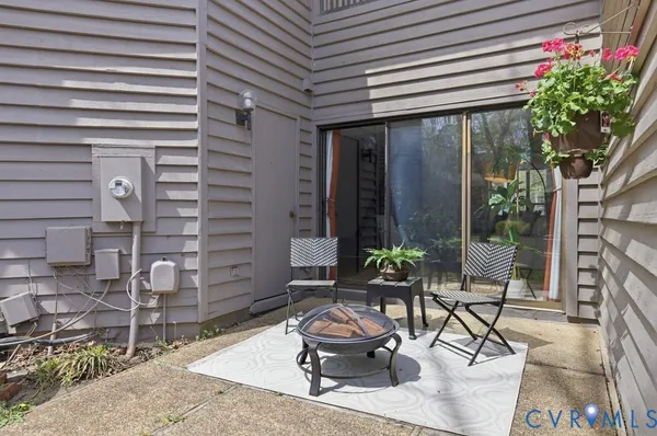 a roof deck with table and chairs a barbeque and potted plants