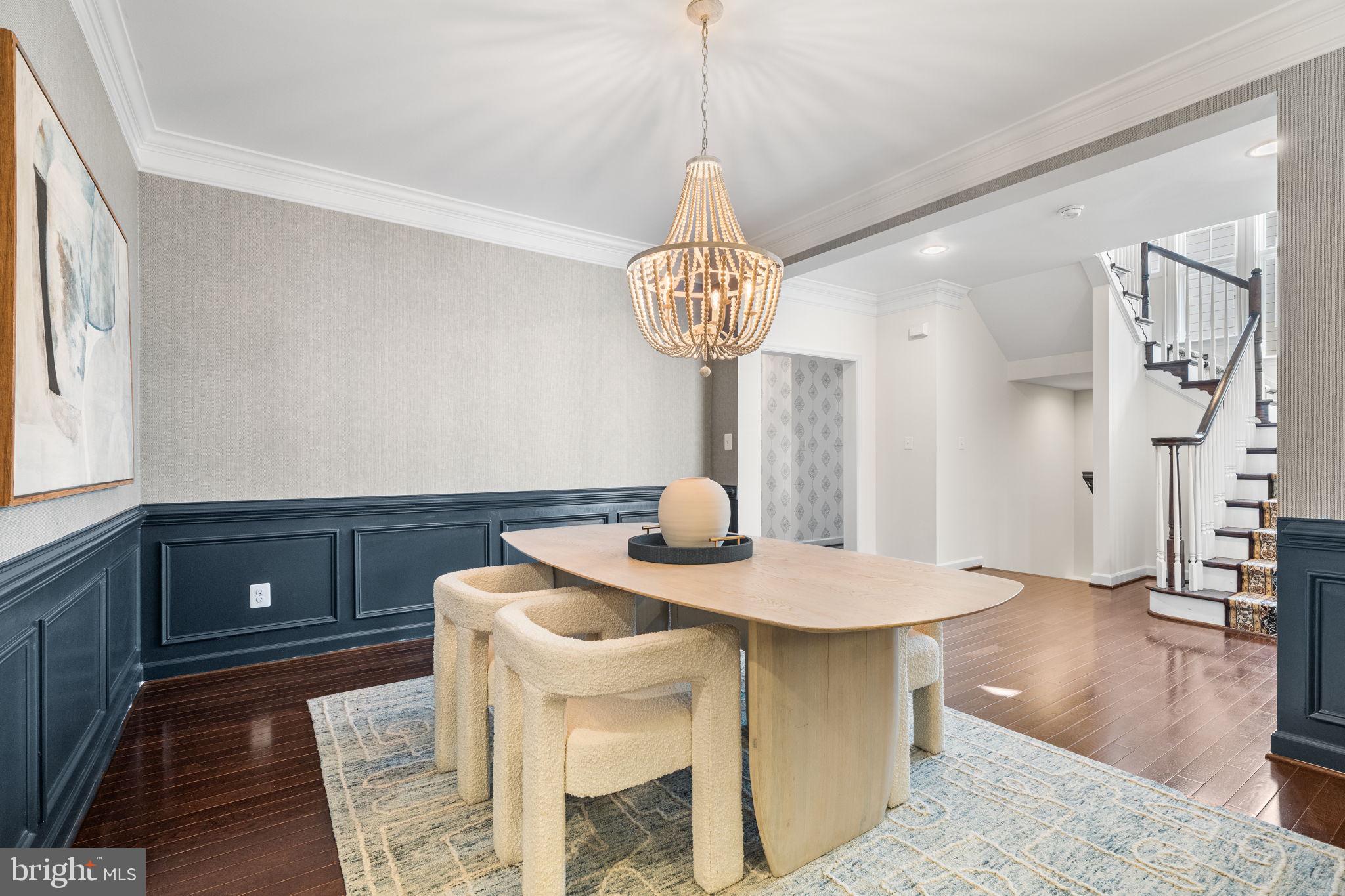 8032 Washington Road Alexandria, VA 22308 - Photo 15 of 50 a view of dining room and kitchen with furniture wooden floor and a chandelier