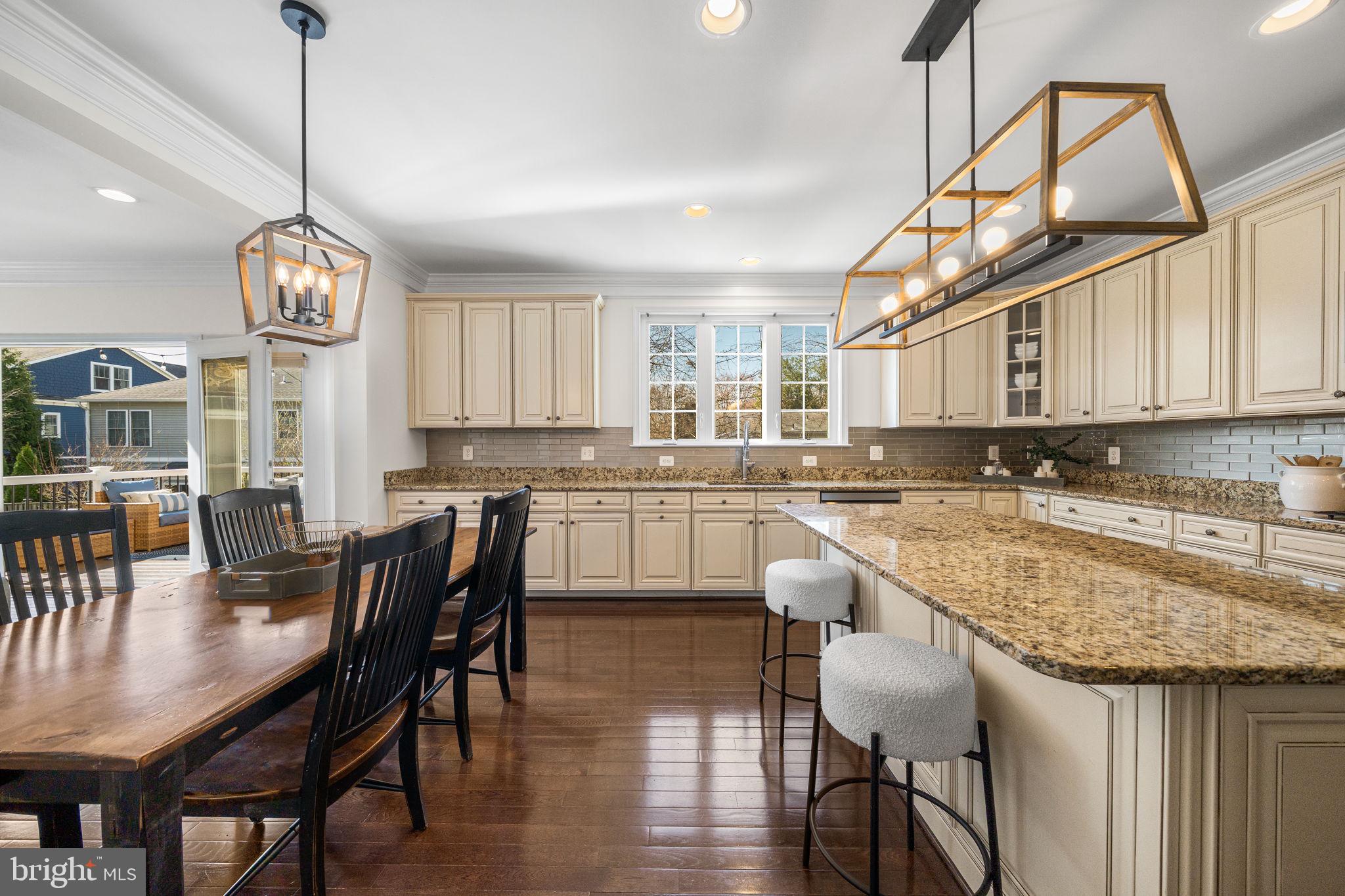 8032 Washington Road Alexandria, VA 22308 - Photo 20 of 50 a kitchen with stainless steel appliances granite countertop a kitchen island a stove a table and chairs