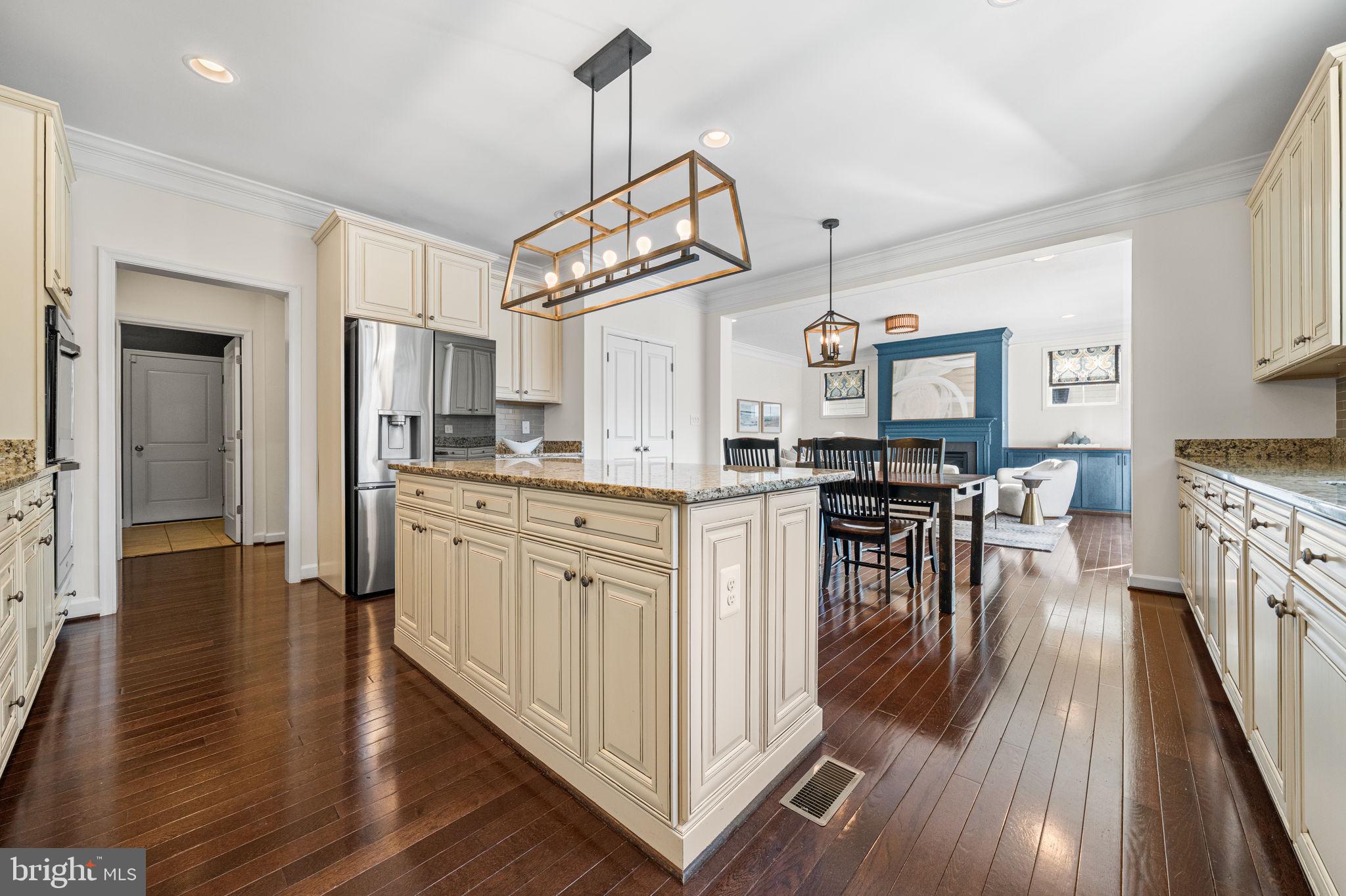8032 Washington Road Alexandria, VA 22308 - Photo 23 of 50 a kitchen with stainless steel appliances granite countertop a refrigerator a stove top oven a sink dishwasher and white cabinets with wooden floor