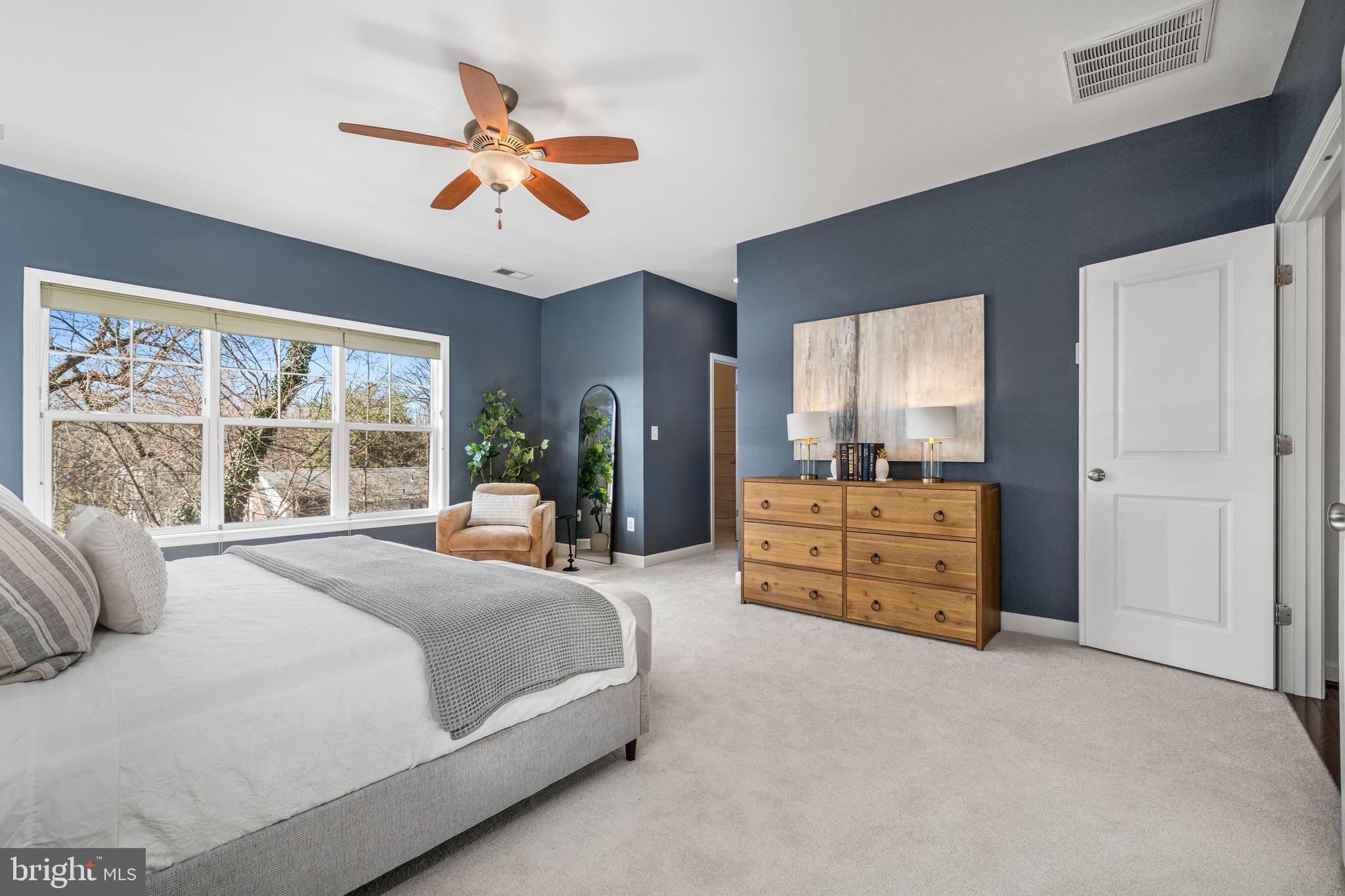 8032 Washington Road Alexandria, VA 22308 - Photo 28 of 50 a bedroom with a bed a large window and dresser