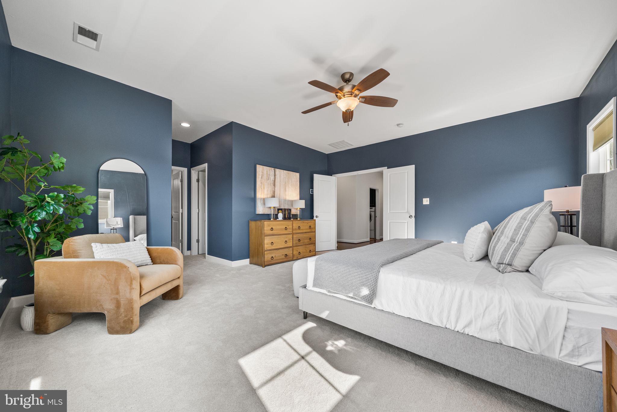 8032 Washington Road Alexandria, VA 22308 - Photo 29 of 50 a bedroom with a bed a couch and dresser