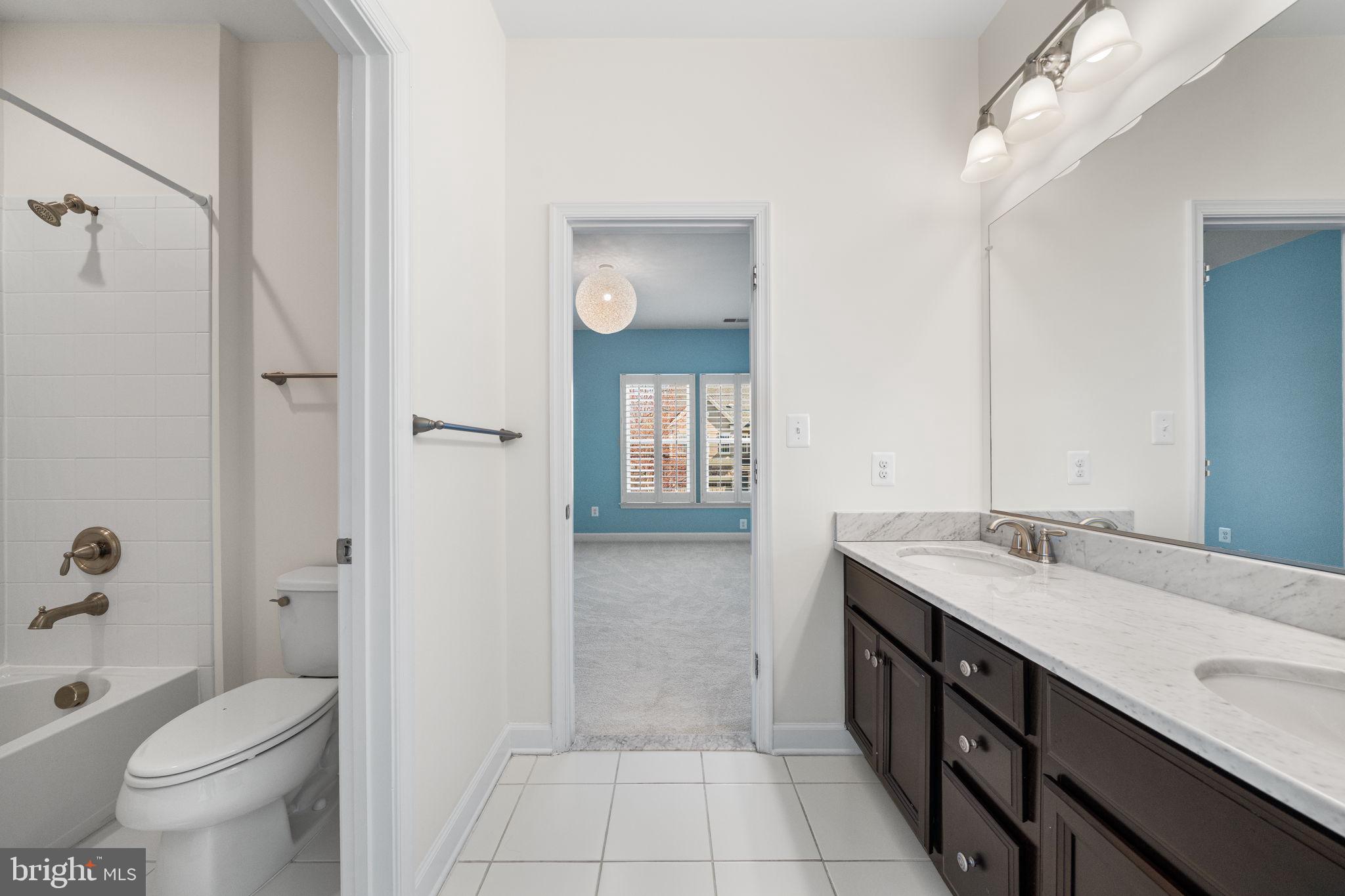 8032 Washington Road Alexandria, VA 22308 - Photo 33 of 50 a spacious bathroom with a granite countertop sink a toilet and shower