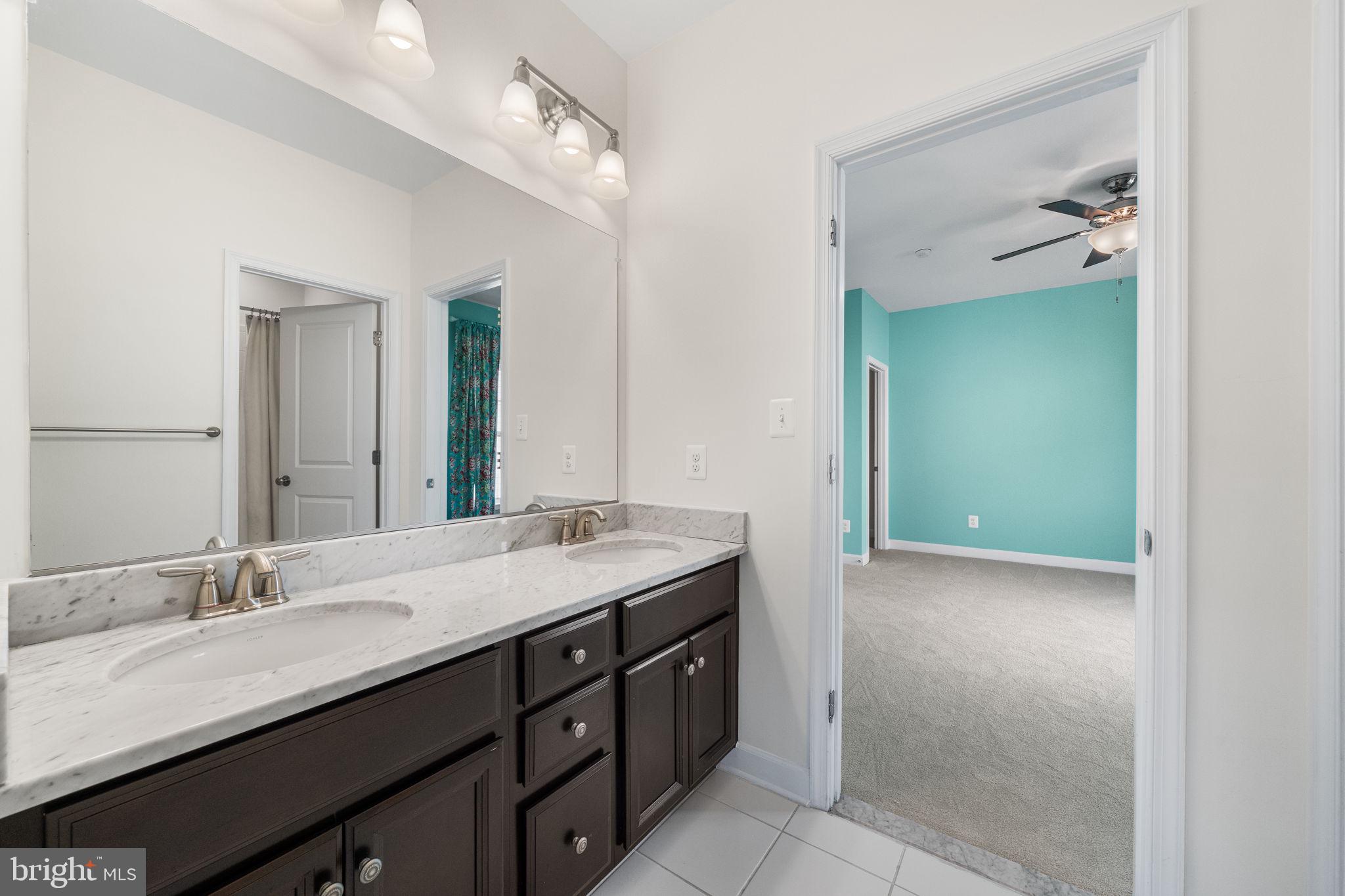 8032 Washington Road Alexandria, VA 22308 - Photo 34 of 50 a bathroom with a granite countertop sink double vanity and a mirror