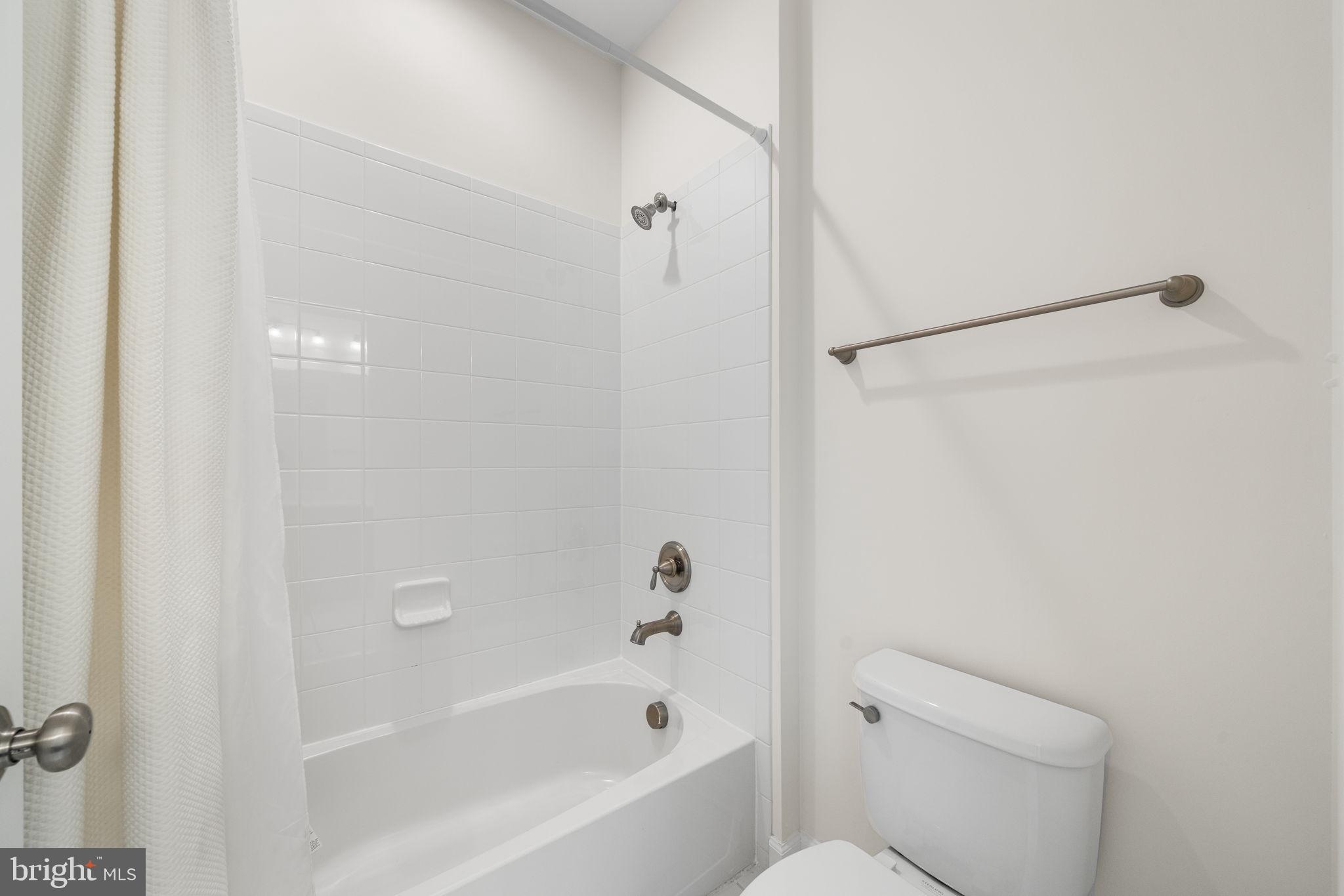 8032 Washington Road Alexandria, VA 22308 - Photo 35 of 50 a bathroom with a bathtub and a toilet