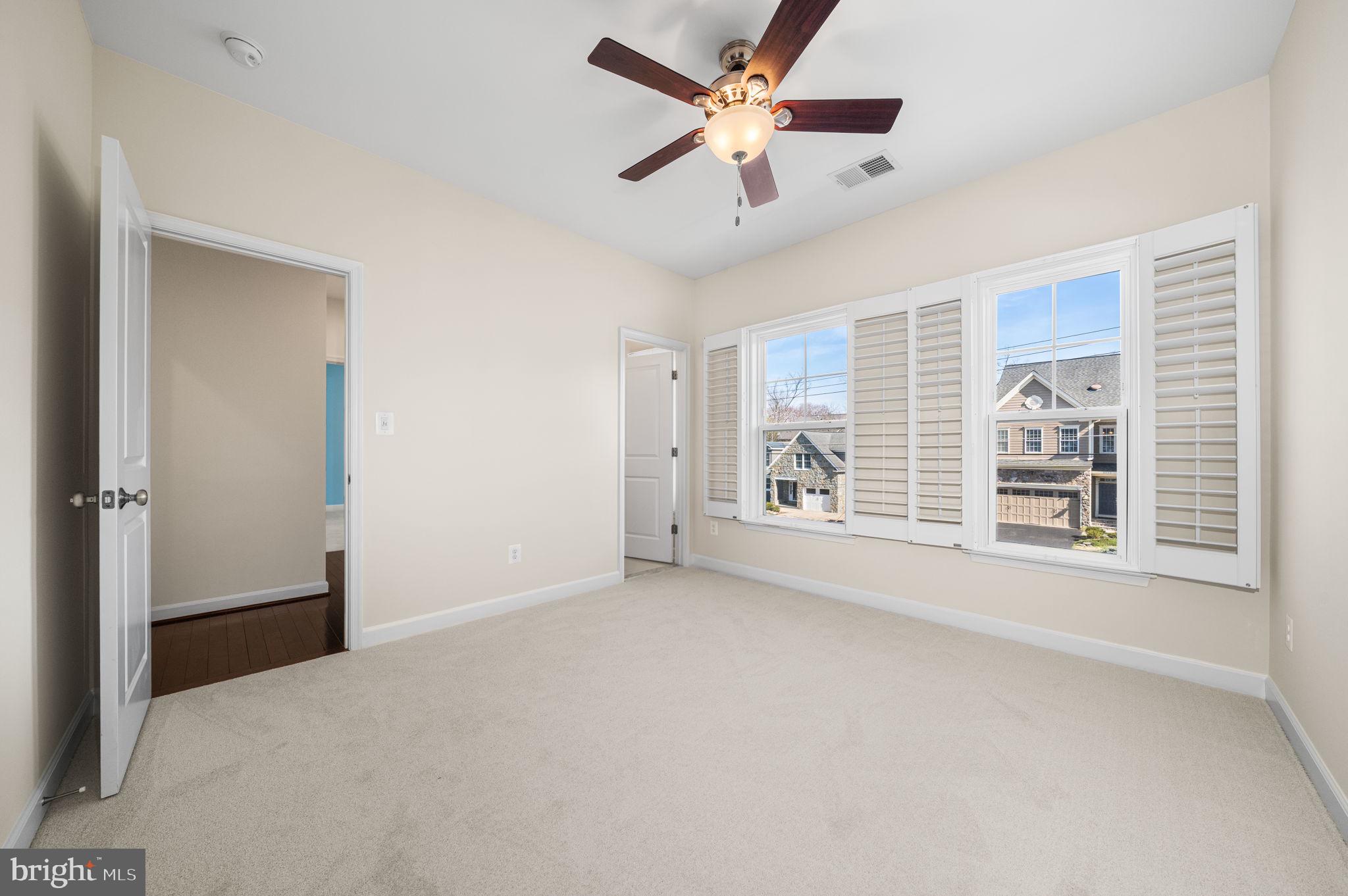 8032 Washington Road Alexandria, VA 22308 - Photo 37 of 50 an empty room with chandelier fan and windows