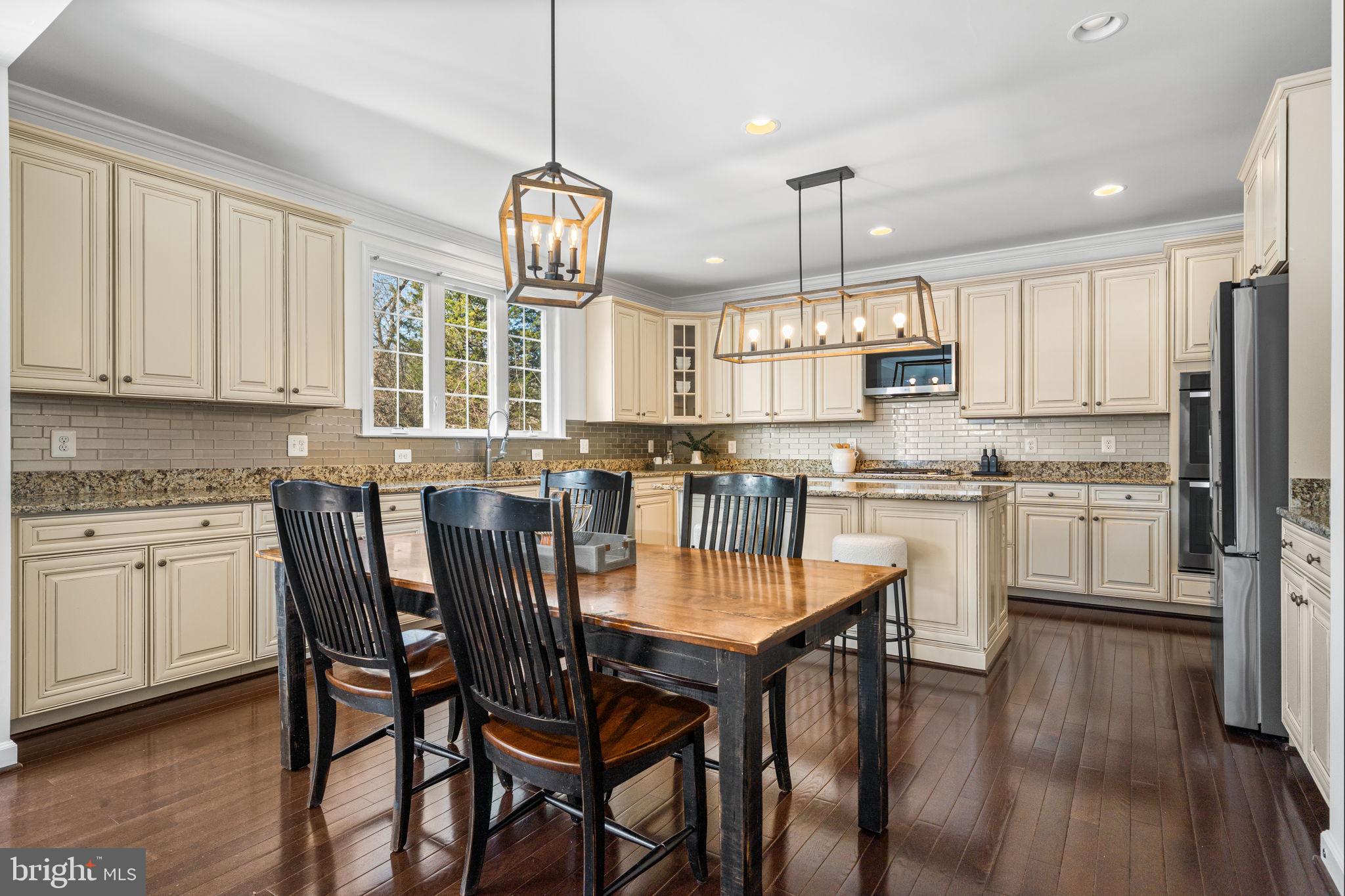 8032 Washington Road Alexandria, VA 22308 - Photo 4 of 50 a kitchen with kitchen island granite countertop a sink a center island and cabinets