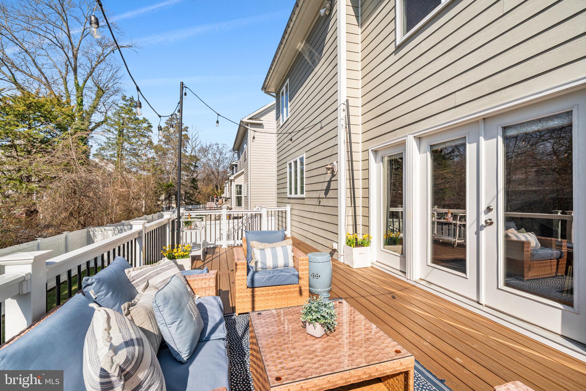 8032 Washington Road Alexandria, VA 22308 - Photo 47 of 50 a view of a patio with couches chairs and wooden floor