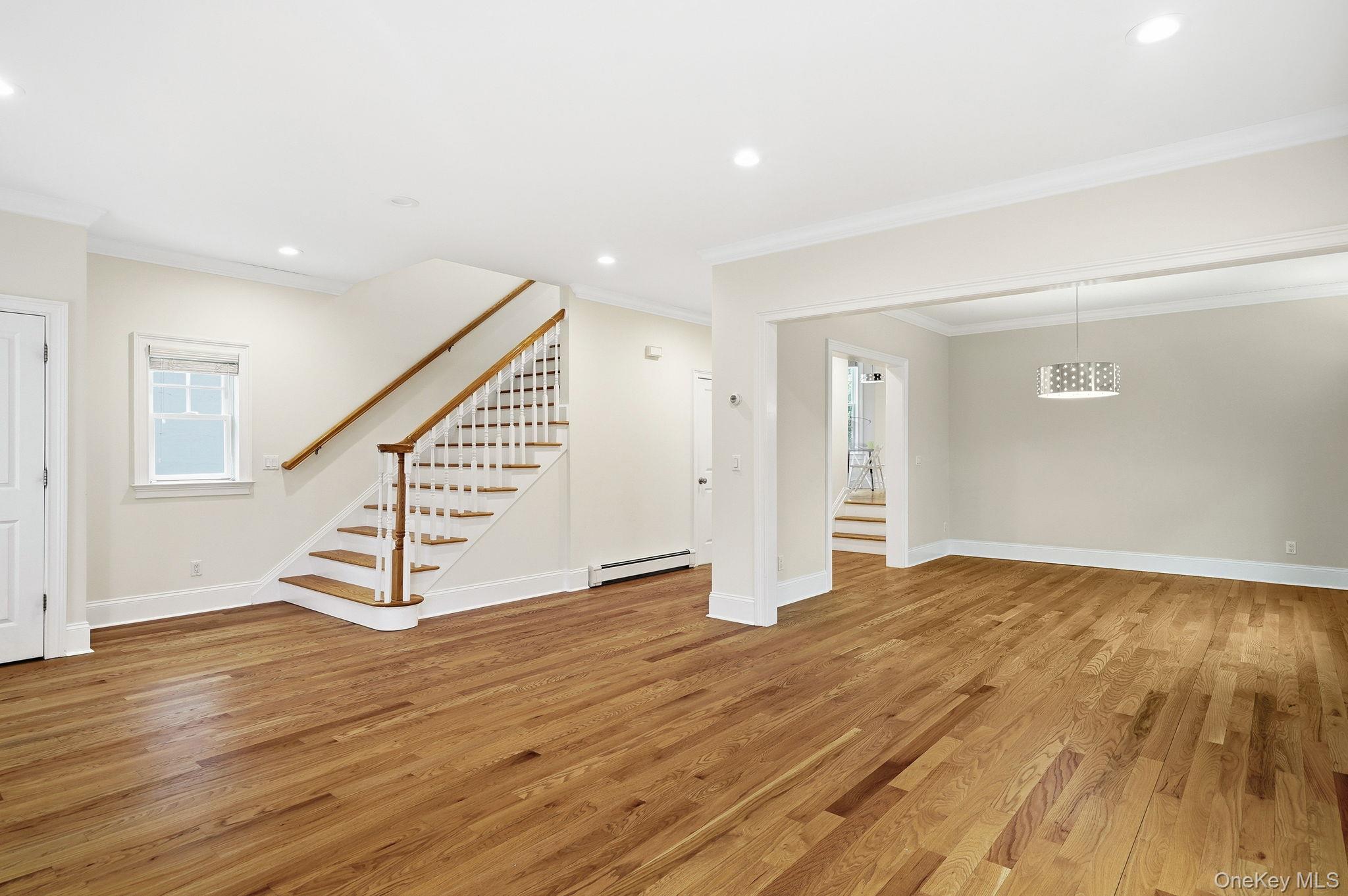 228 Central Avenue Rye, NY 10580 - Photo 4 of 24 a view of an empty room with wooden floor and stairs