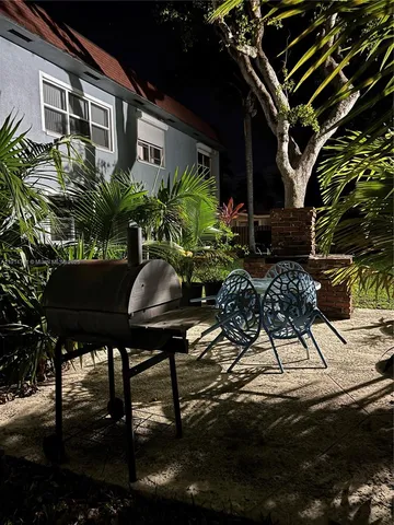 a backyard of a house with table and chairs