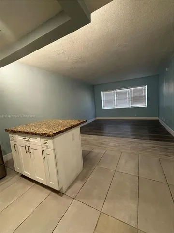 a kitchen with granite countertop white cabinets and a granite counter tops
