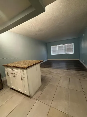 a kitchen with granite countertop white cabinets and a granite counter tops