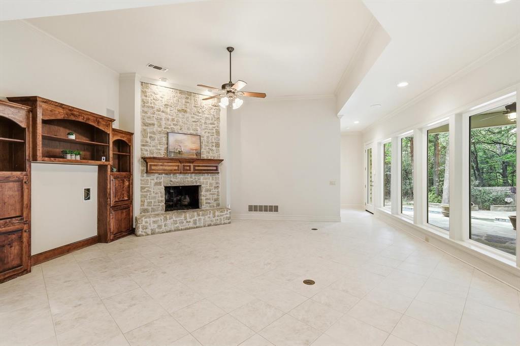 970 Crystal Cove Oak Point, TX 75068 - Photo 13 of 40 a view of an empty room with a fireplace and a window
