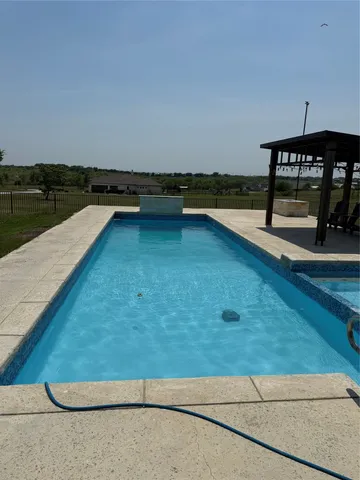 a view of a swimming pool with an outdoor seating