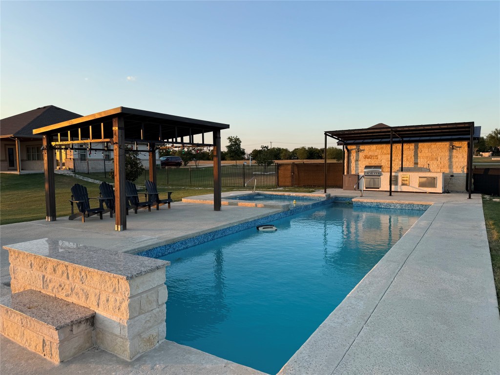 474 Peck Street Kyle, TX 78640 - Photo 12 of 15 a view of a swimming pool with an outdoor seating