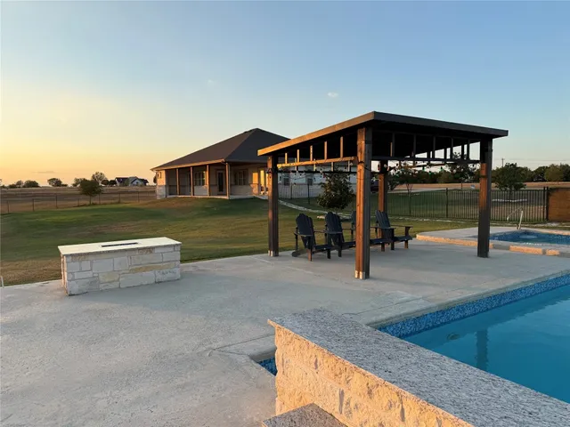 a view of a swimming pool with a lounge chair