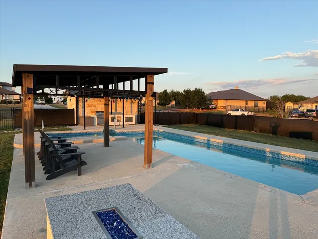a view of a patio with a table and chairs